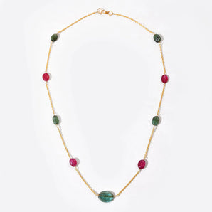 Necklace with green and red beads on a white background