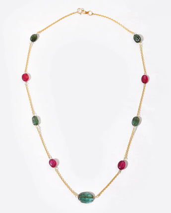 Necklace with green and red beads on a white background