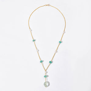 Necklace with pearls and green beads on a white background