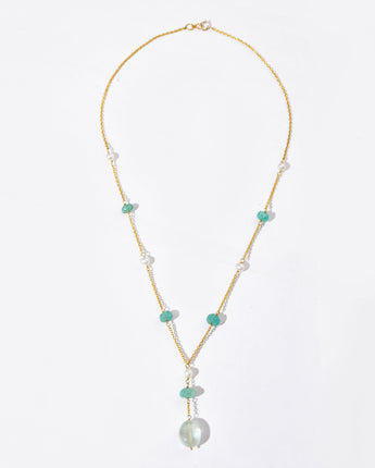 Necklace with pearls and green beads on a white background