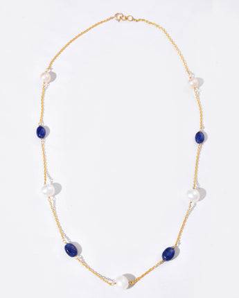 Necklace with blue and white beads on a white background