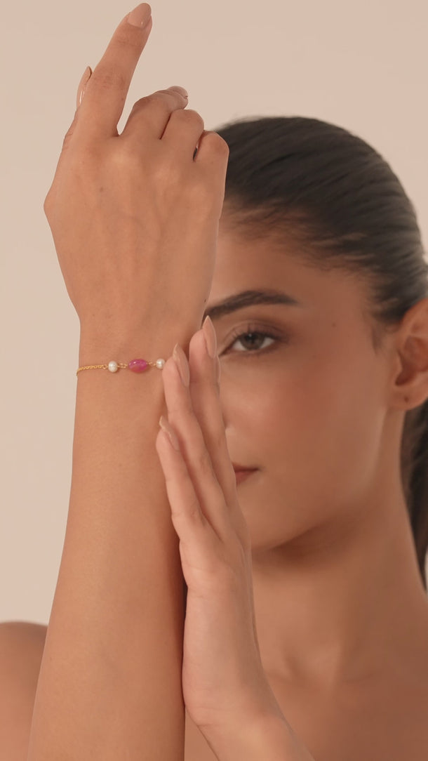 Woman wearing a gemstone bracelet in her hand